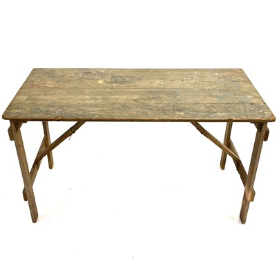 Lot 150 - A pine topped trestle table.