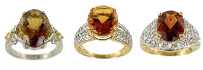 Lot 214 - Two contemporary 9ct golden citrine and white stone set dress rings and a silver ring.