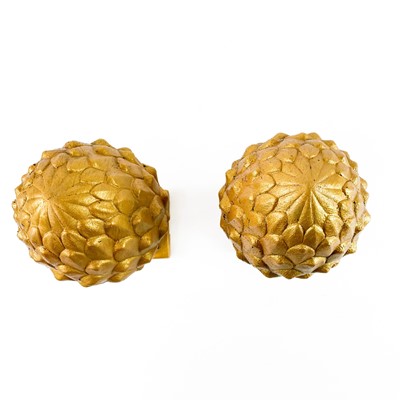 Lot 607 - Pair of stone acorns painted gold.