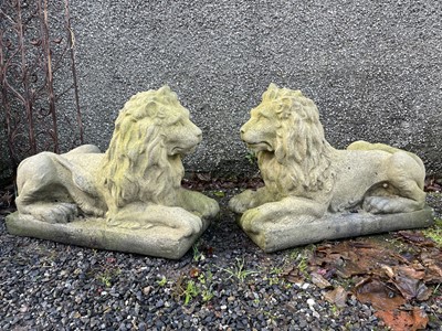 Lot 207 - A pair of reconstituted stone recumbent lions.