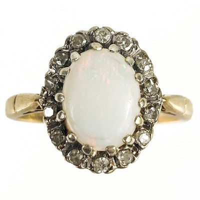 Lot 11 - A modern 9ct white opal and diamond set cluster ring.