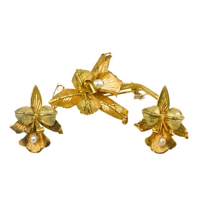 Lot 57 - An 18ct bi-colour gold pearl set flower brooch and matching stud earrings.