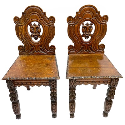 Lot 139 - A pair of Victorian oak hall chairs.