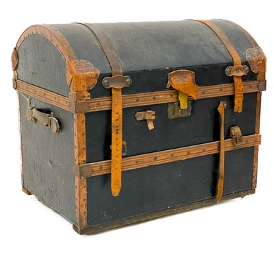 Lot 1843 - A leather and copper bound domed top trunk.