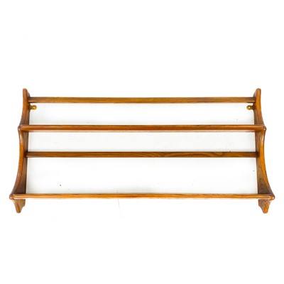 Lot 1827 - An Ercol elm wall hanging plate rack.