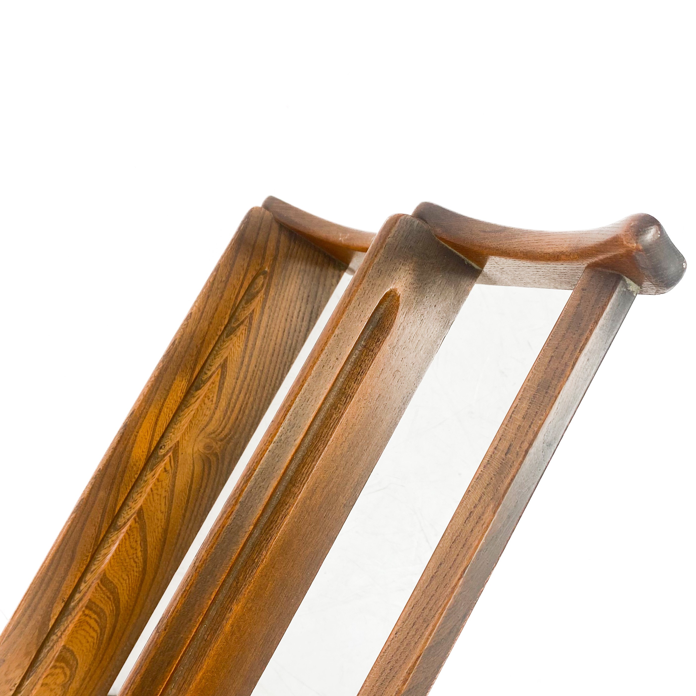 Lot 1827 - An Ercol elm wall hanging plate rack.