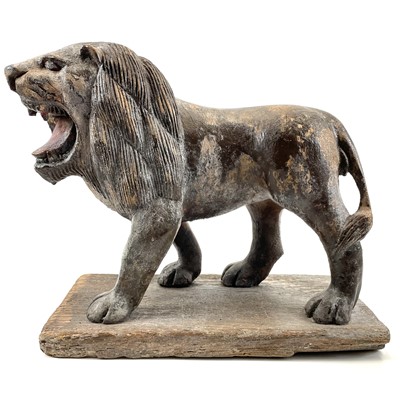 Lot 159 - A carved wood and painted figure of a lion.