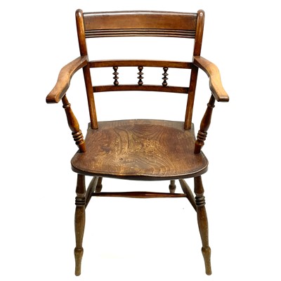 Lot 192 - A Victorian fruitwood and elm bar back kitchen elbow chair.