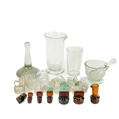 Lot 910 - A glass muller, with a ground base, and a pestle and mortar.