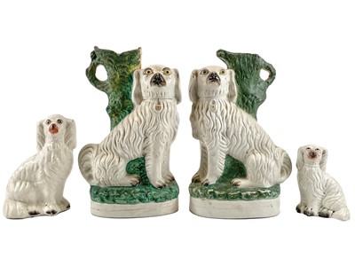 Lot 250 - A pair of 19th century Staffordshire pottery spaniel spill vases.