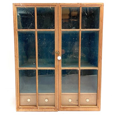 Lot 253 - A 19th century pine glazed cabinet.