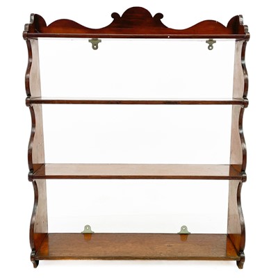 Lot 1910 - A mahogany hanging shelf rack.