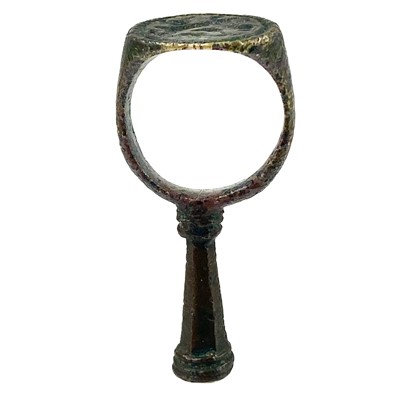 Lot 231 - A 17th century copper-alloy seal and pipe tamper ring.