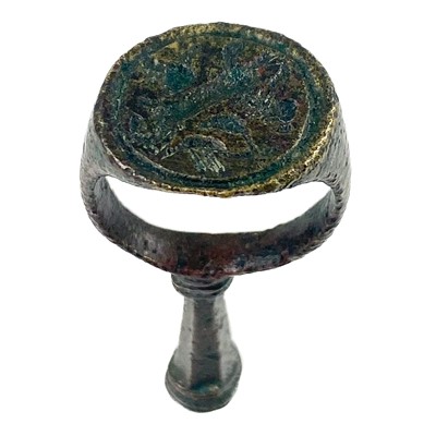 Lot 231 - A 17th century copper-alloy seal and pipe tamper ring.