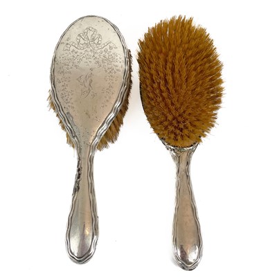 Lot 295 - Six silver backed brushes and a silver backed hand mirror.