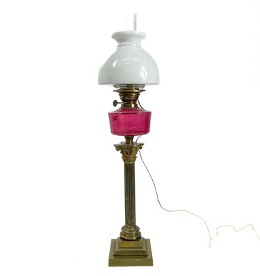 Lot 281 - A converted Victorian oil lamp with cranberry glass well and white glass shade.