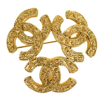 Lot 396 - A Chanel triple CC gold plated brooch.