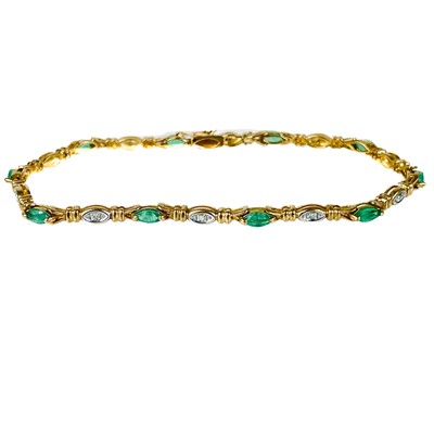 Lot 96 - A modern 9ct gold diamond and emerald set bracelet.