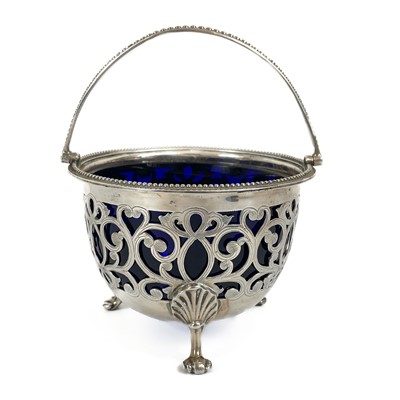 Lot 123 - A Victorian silver swing handled basket with blue glass liner by Henry Wilkinson & son.