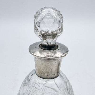 Lot 101 - A Edwardian Silver matchbox holder, a silver cream jug and a glass bottle with silver collar.