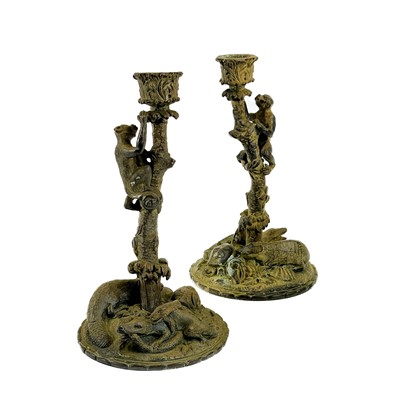 Lot 55 - A pair of bronze candlesticks.