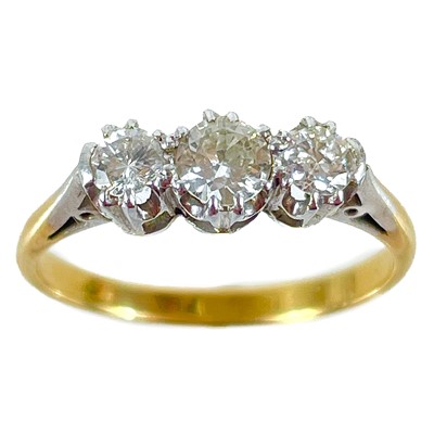 Lot 130 - An 18ct and platinum diamond set three stone ring.