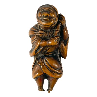 Lot 279 - A Japanese carved wood netsuke, Meiji period, signed.