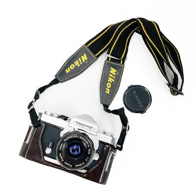 Lot 171 - A Nikkormat manual camera together with other camera attachments.