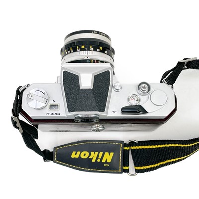 Lot 171 - A Nikkormat manual camera together with other camera attachments.