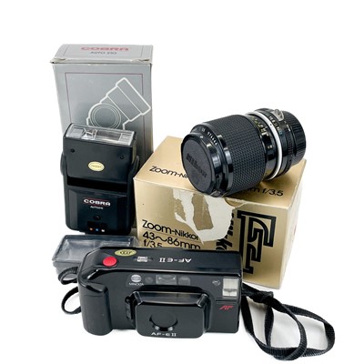 Lot 171 - A Nikkormat manual camera together with other camera attachments.