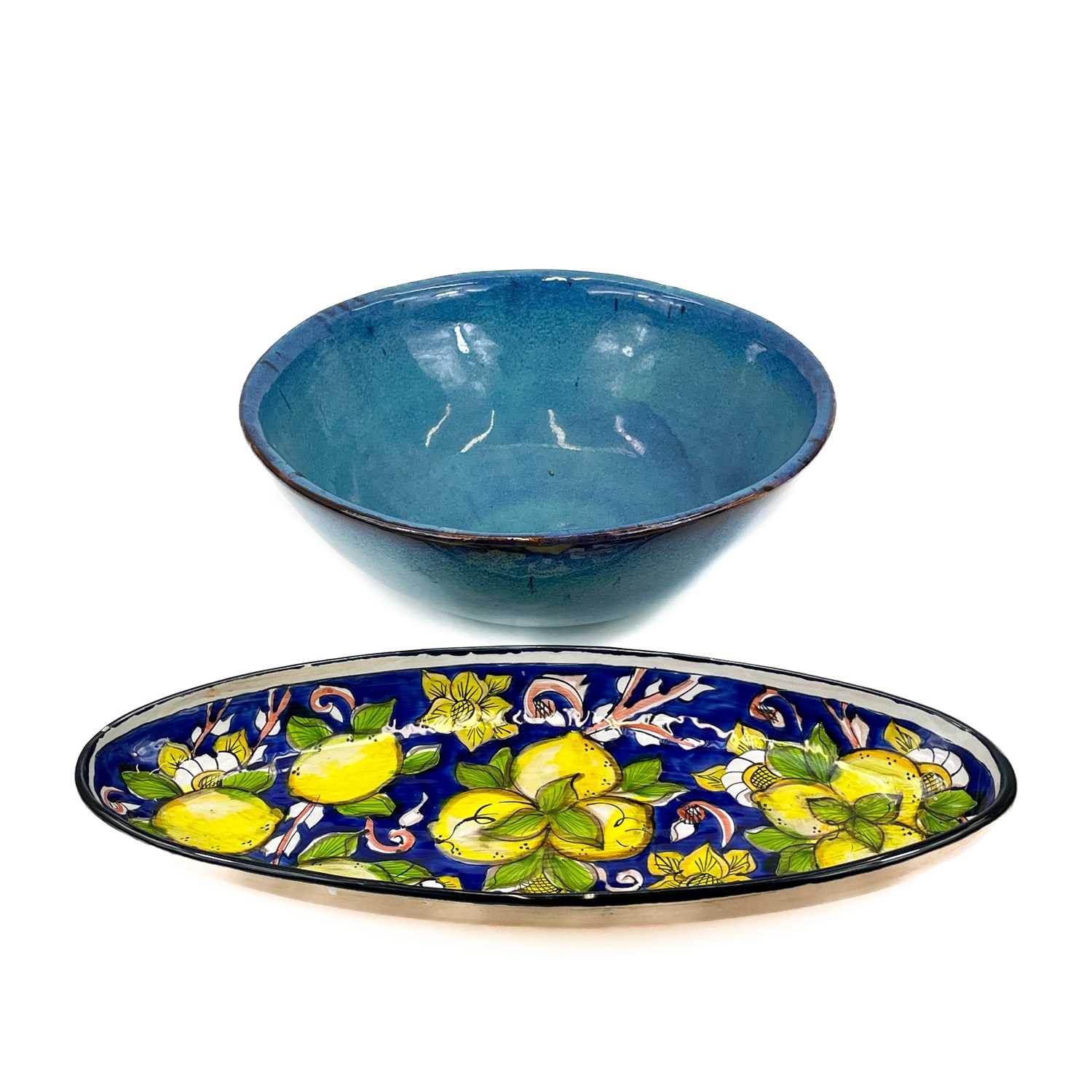 Lot 819 - A large studio pottery fruit bowl together with an oval serving dish.