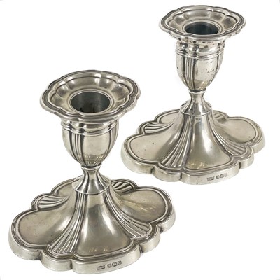 Lot 279 - A pair of George VI silver squat candlesticks by Mappin & Webb.