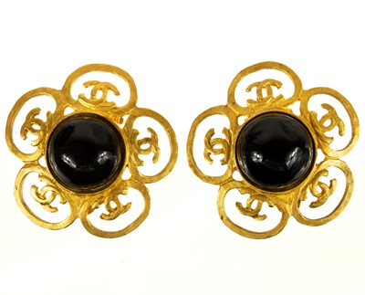 Lot 364 - A Chanel gold tone pair of Gripoix black clover earrings.