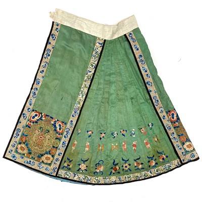 Lot 43 - A Chinese green silk embroidered skirt, late 19th century.