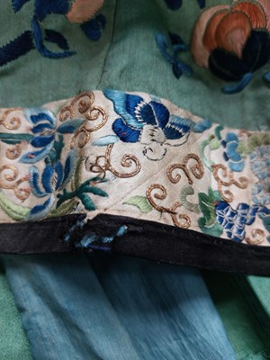 Lot 43 - A Chinese green silk embroidered skirt, late 19th century.