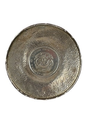 Lot 216 - A Chinese coin set hammered silver dish.