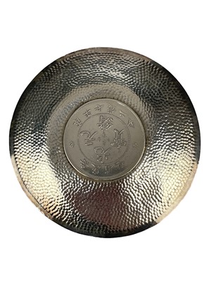 Lot 328 - A Chinese coin set hammered silver dish.