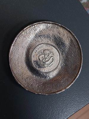 Lot 328 - A Chinese coin set hammered silver dish.