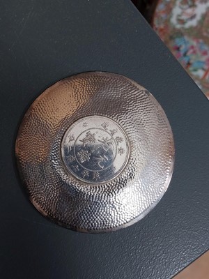 Lot 328 - A Chinese coin set hammered silver dish.