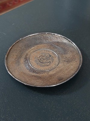Lot 328 - A Chinese coin set hammered silver dish.