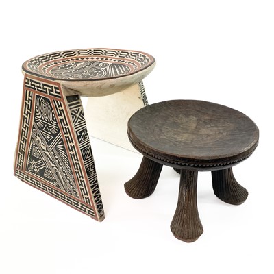 Lot 196 - An African carved circular tripod stool.