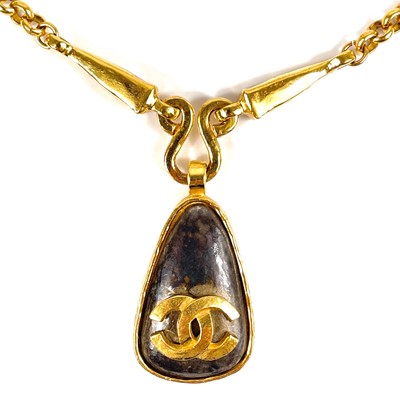 Lot 356 - A Chanel brown stone set pendant necklace.