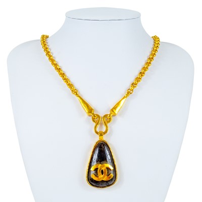 Lot 356 - A Chanel brown stone set pendant necklace.