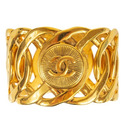 Lot 399 - A Chanel CC medallion wide cuff bangle.