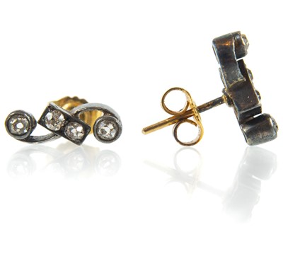 Lot 157 - A pair of early 20th century bi-colour gold and diamond set stud earrings.