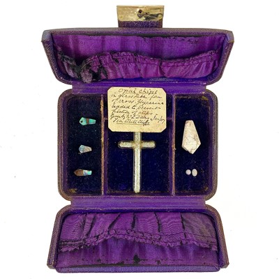 Lot 284 - A glass cross with white opal chips and hand written note dated Jan/07.