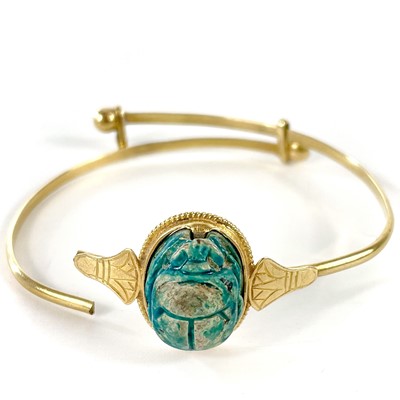 Lot 144 - A 19th century Grand Tour high purity gold Egyptian scarab bangle.