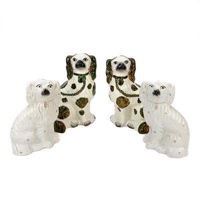 Lot 125 - A pair of Victorian Staffordshire green and copper lustre spaniels.