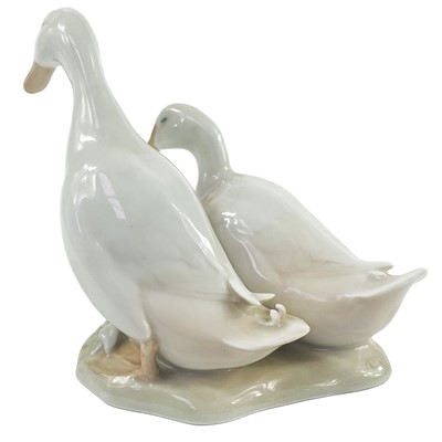 Lot 890 - A collection of four Royal Copenhagen figures of girls and geese.