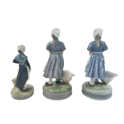 Lot 890 - A collection of four Royal Copenhagen figures of girls and geese.